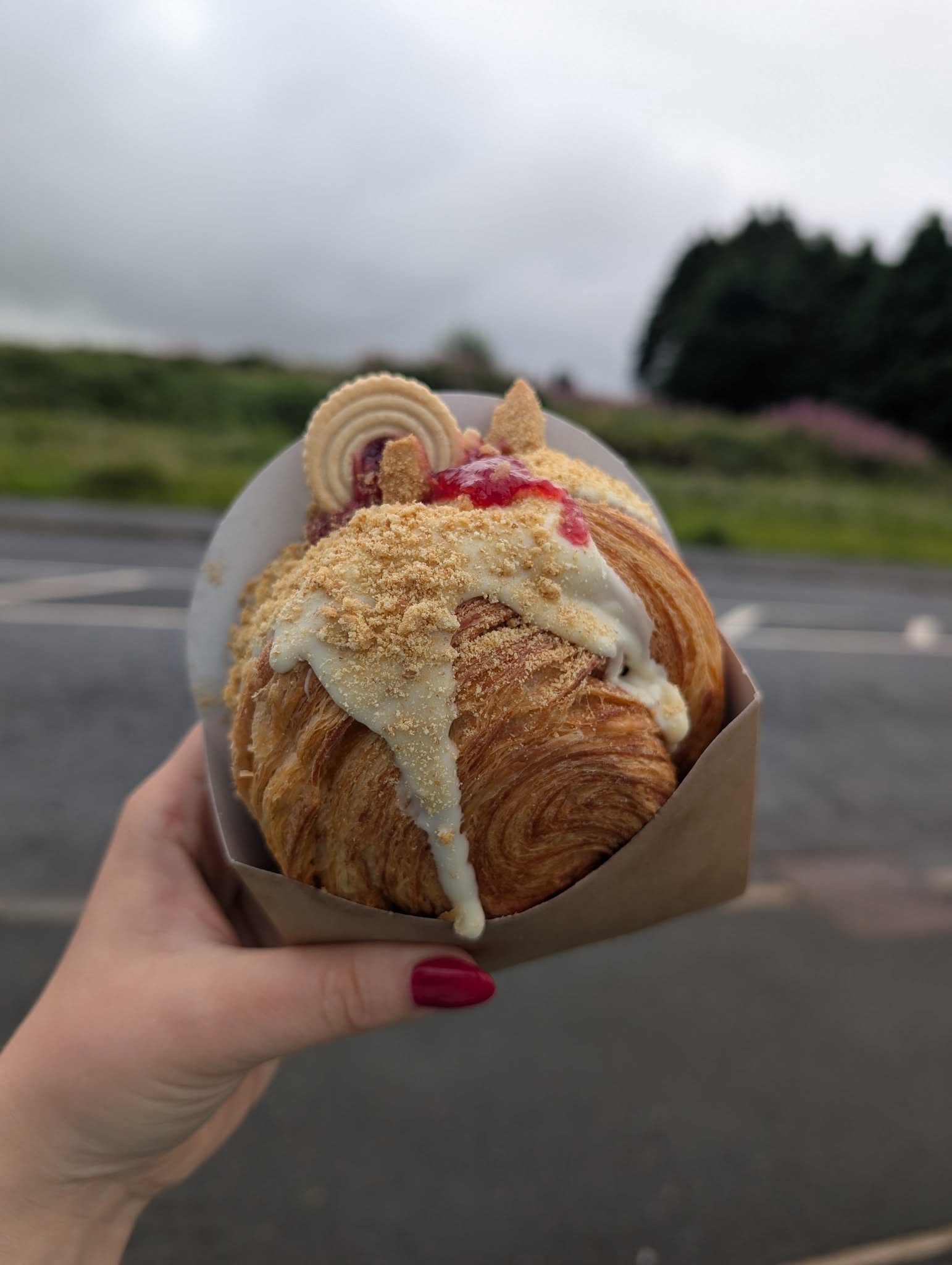 Croissant topped with white chocolate, jam and biscuit crumb
